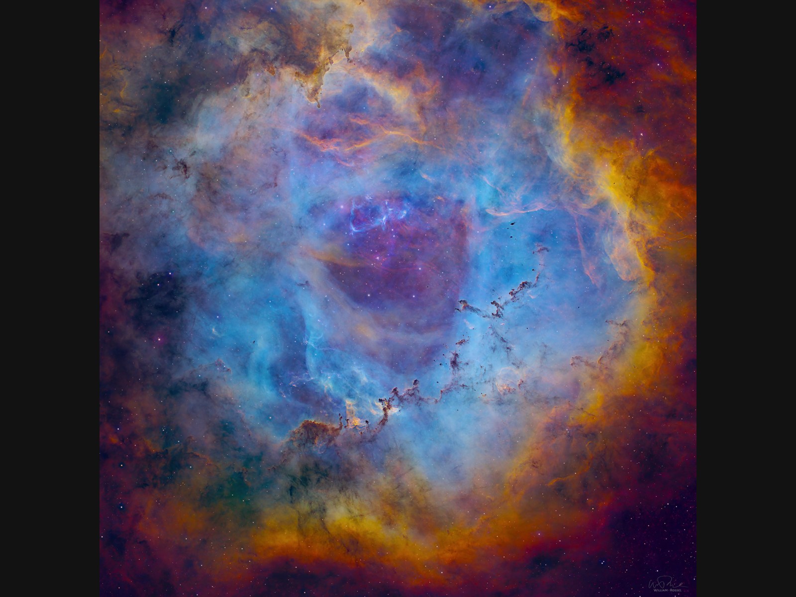 Colorful astrophotograph by William Rossel showing a nebula in blue, violet, red, and gold